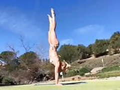 Britney Spears doing yoga outdoors in a bikini