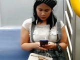 Cute asian on the train in Boots and a skirt. Cutie