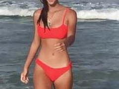 Hot young babe in orange bikini at the beach Free XXX | xvideosearch.com