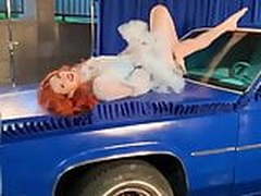 Bella Thorne posing on the hood of a car